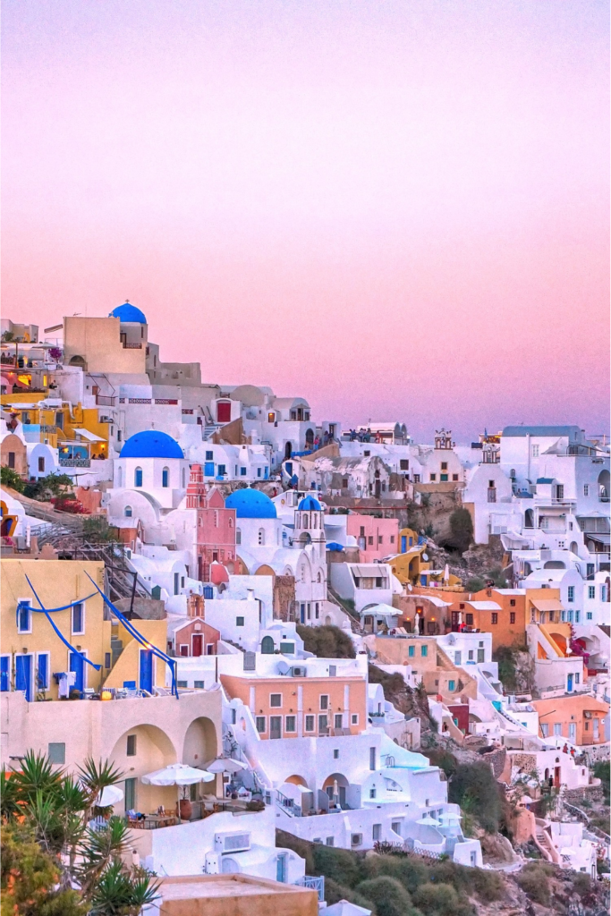 Santorini, Greece
Whitewashed buildings with blue-domed roofs perched on cliffs, sparkling turquoise waters, and sunsets that light up the sky in shades of pink and orange.