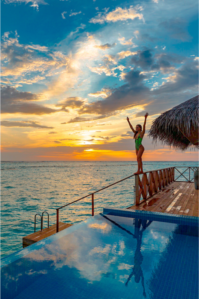 A dreamy overwater bungalow perched above turquoise waters, with hammocks and a private infinity pool overlooking the horizon.