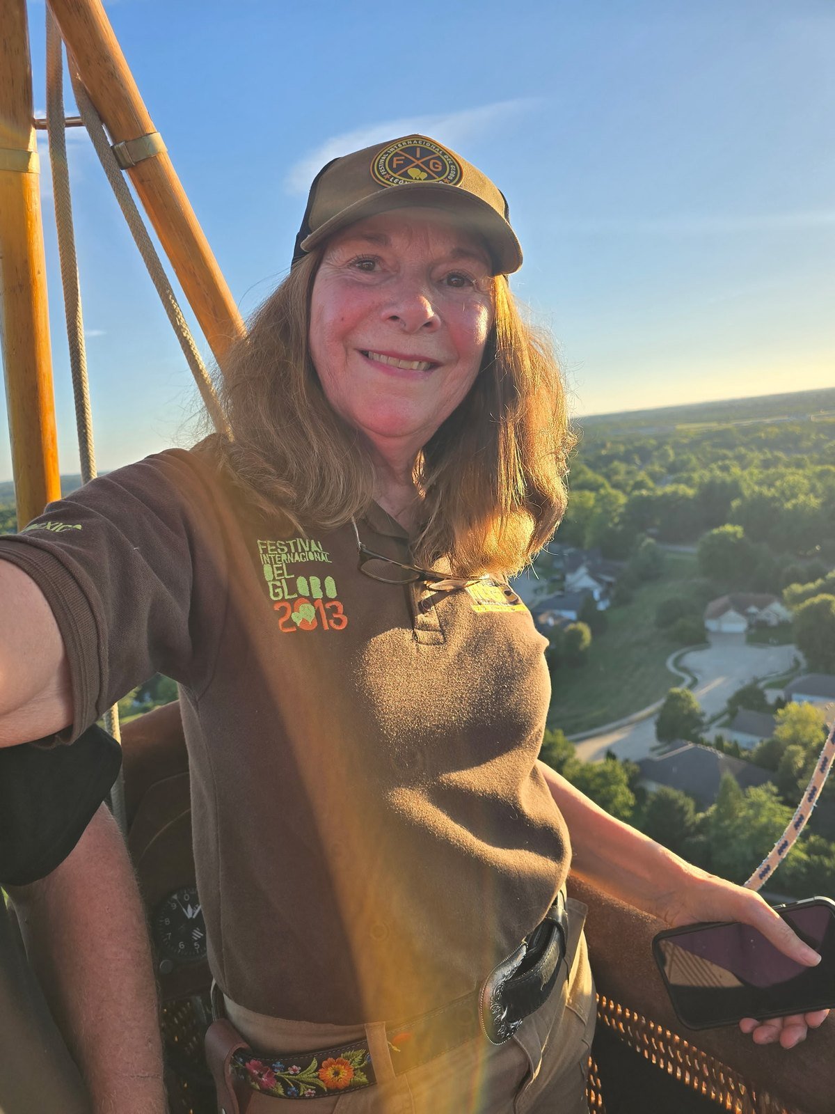 Hot air balloon pilot Jan smiling in the basket high above Columbia, Missouri