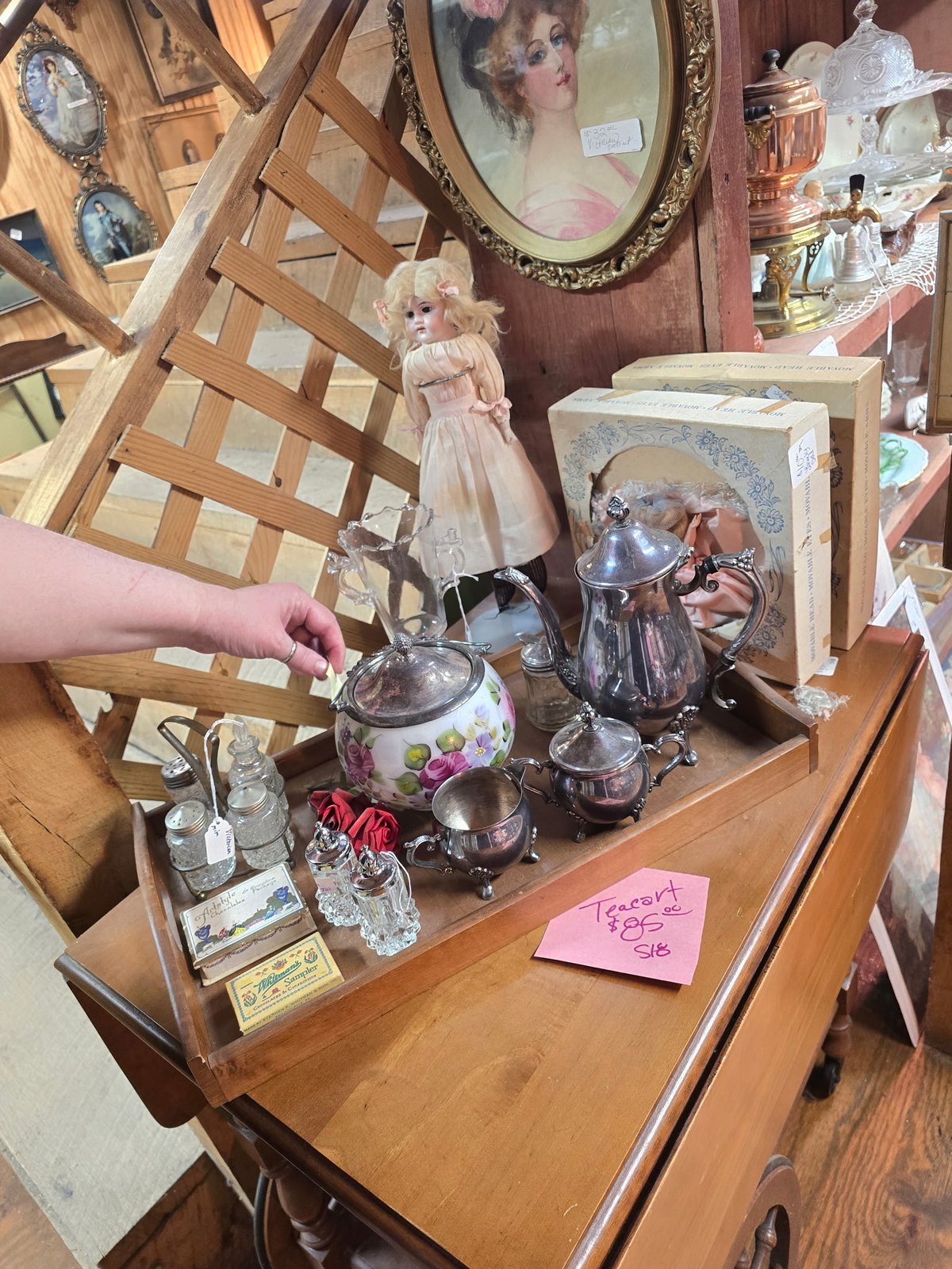 Vintage wooden teacart with silver tea set and hand-painted biscuit jar