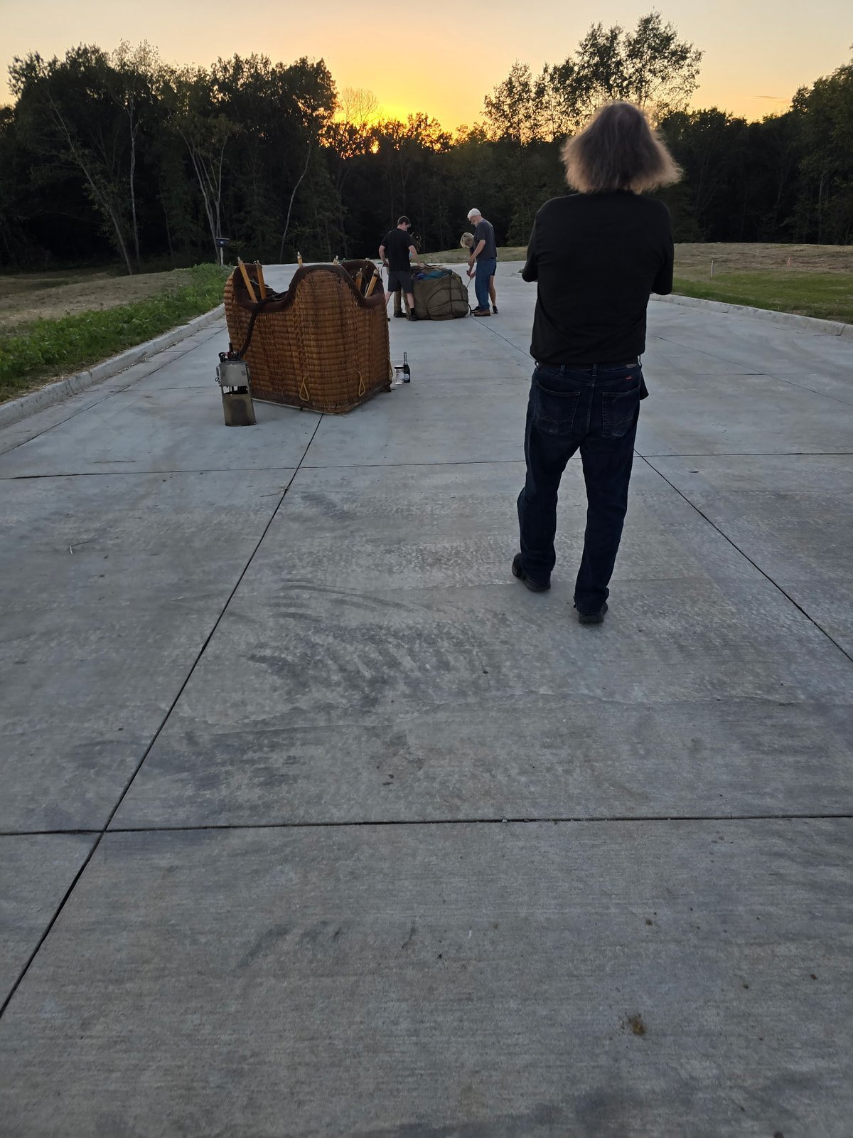 Balloon basket and crew on a quiet street at sunset after landing