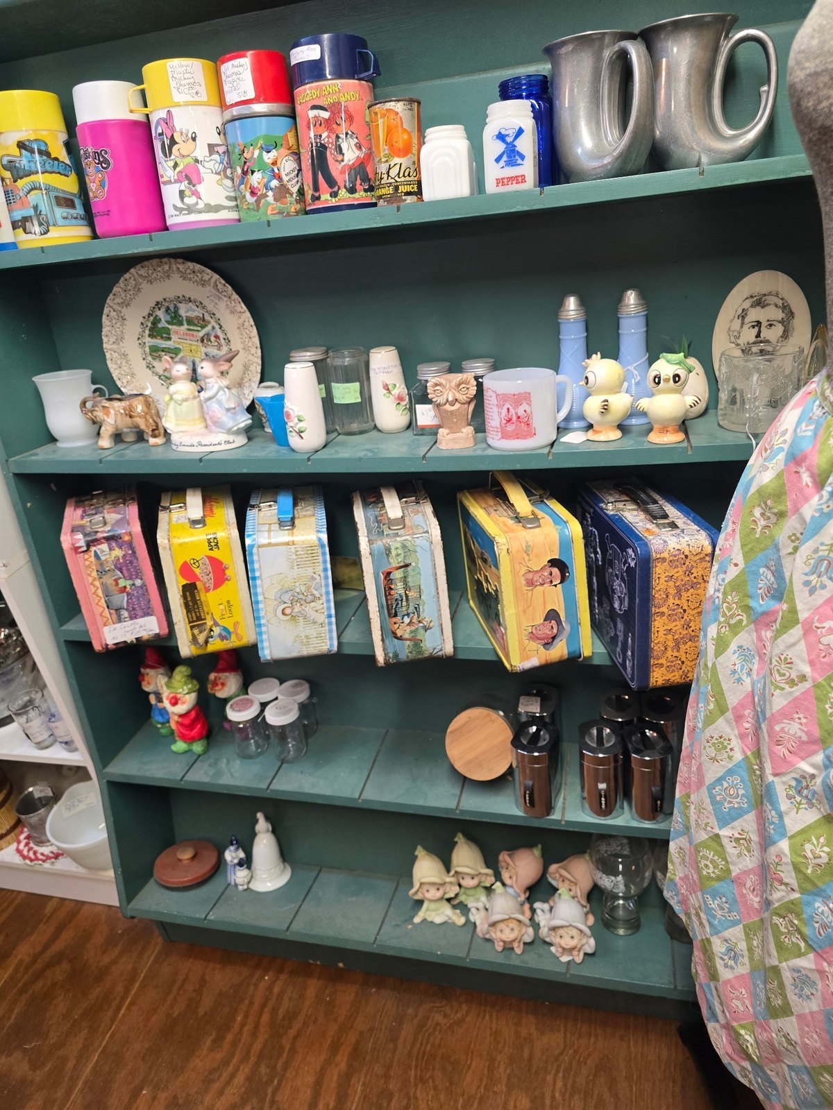 Shelf of vintage metal lunchboxes and thermoses