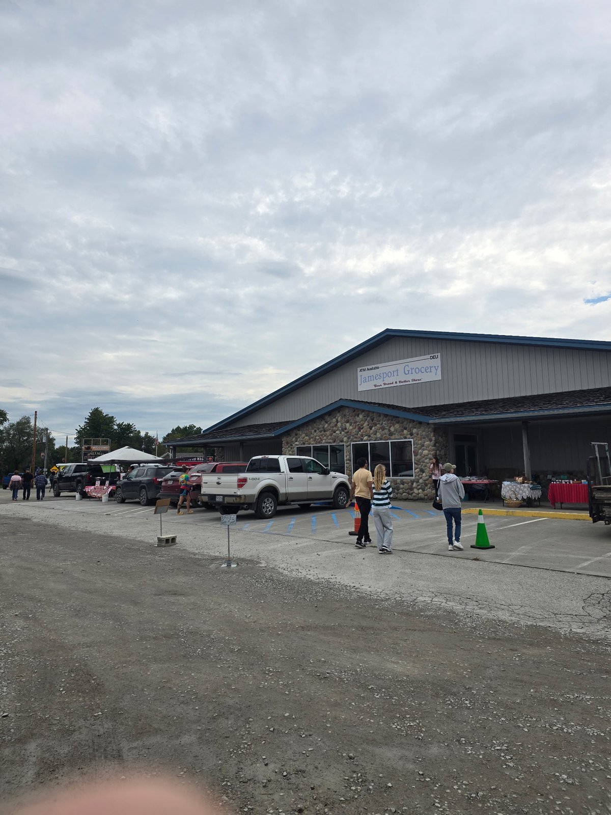 Jamesport Grocery storefront with vendor tables out front