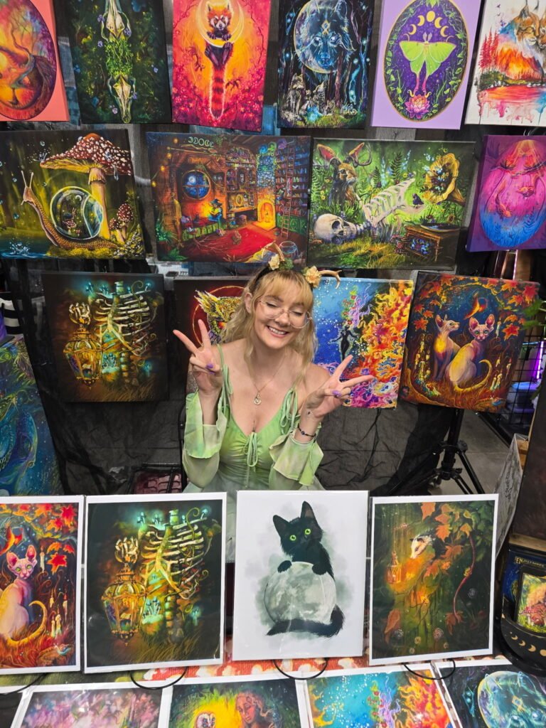 Artist displaying colorful original artwork at GalaxyCon Des Moines