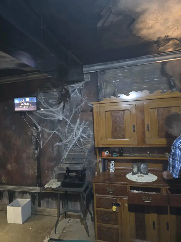 Antique hutch, vintage sewing machine and countdown timer in the Burn escape room